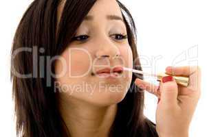 beautician doing the lip make up of female