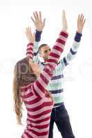 people with raised arms and looking upward
