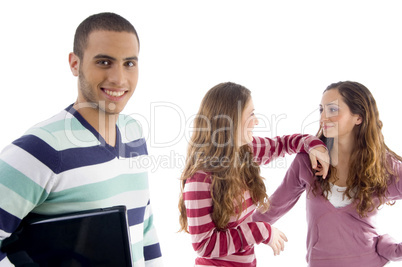 two girls holding to each other and guy looking at camera