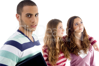 two girls holding to each other and guy looking at camera