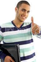 smiling guy holding notebook showing thumbs up