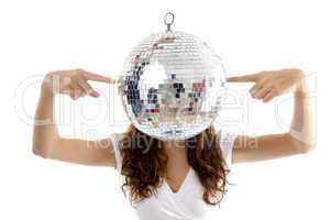 woman balancing mirror ball with fingers