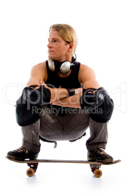 male sitting on skate board