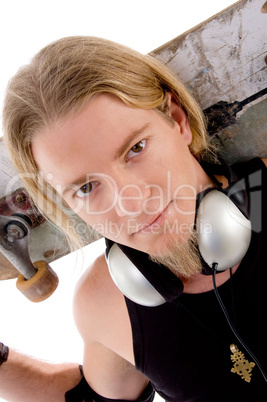 close up view of handsome guy with skateboard