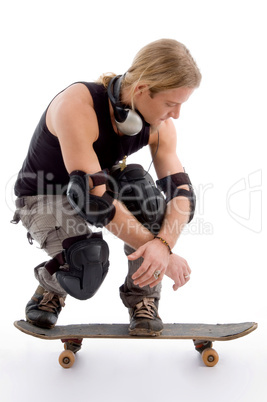 handsome american male sitting on skateboard