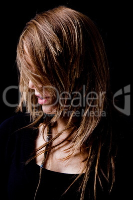 portrait of young woman hiding her face with hair