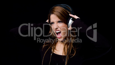 portrait of shouting woman listening music