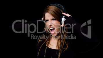 portrait of shouting woman listening music