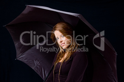 portrait of smiling female holding umbrella