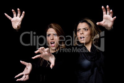 portrait of surprised young women showing hand gesture