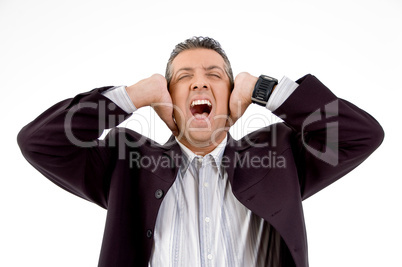 front view of shouting businessman putting hands on his ears