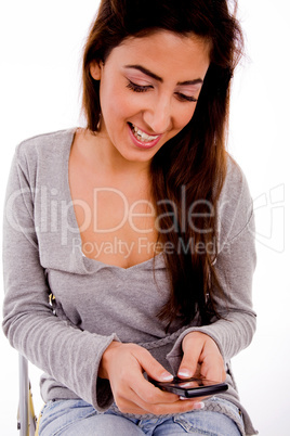 front view of smiling woman looking the mobile