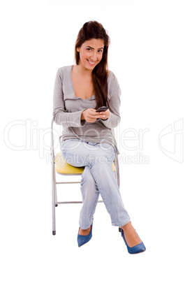 front view of smiling woman holding mobile