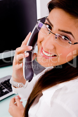 side pose of smiling professional talking on phone