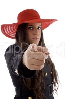 beautiful young female wearing hat pointing