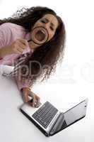 smart young businesswoman with laptop and magnified mouth