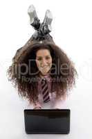 smart young businesswoman lying down with laptop