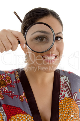 smiling female watching through magnifying lens