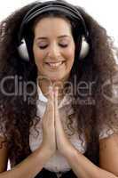 young woman listening to music and praying