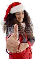 young woman with christmas hat showing thumb up