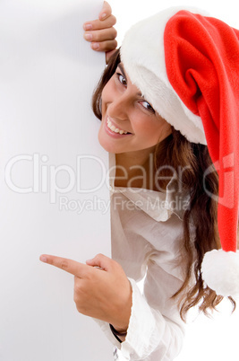 female wearing christmas hat and pointing placard