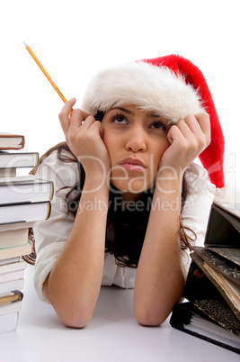 young american student in christmas hat with heap of books