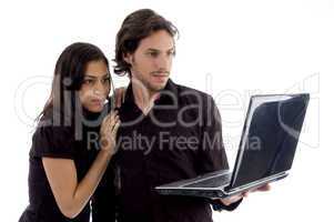 young couple looking into laptop