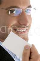 close up of young good looking man with business card