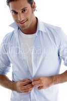 man tucking his shirt buttons