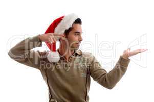 young man wearing christmas hat and indicating to his hand