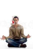 handsome man wearing christmas hat and doing meditation