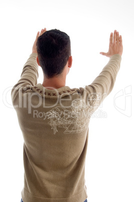 young man framing something and posing from back