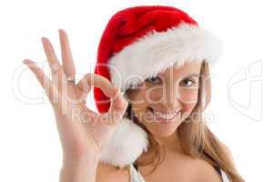 model with christmas hat and showing ok sign