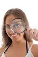 smiling model holding magnifying glass