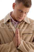 praying male looking at camera
