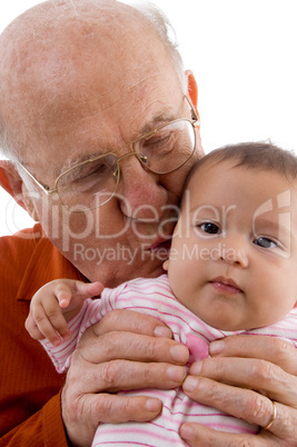 old man kissing the cute baby