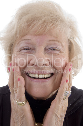 portrait of smiling old woman holding her face