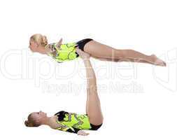 Two young gymnasts in green show exercise isolated