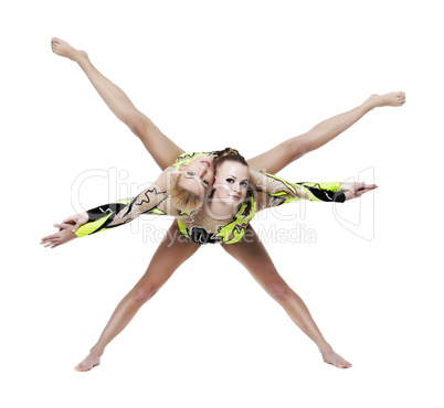 Two young woman show high gymnastic exercise