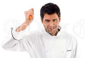 portrait of young male chef holding dagger