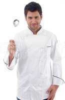 young chef holding slotted spoon