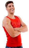 smiling muscular man posing with crossed arms