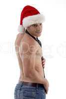 shirtless male model posing with christmas hat