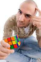 confused man holding puzzle cube