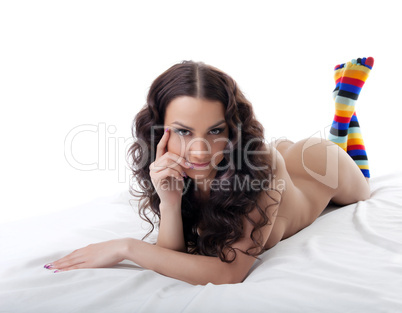 Young nude woman lay in color socks isolated