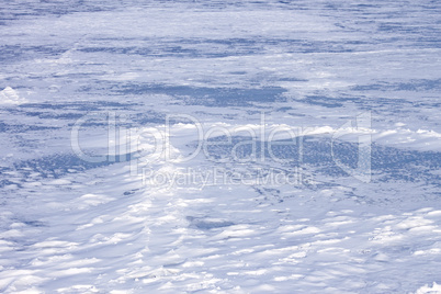 Snow hummocks on frozen reservoir