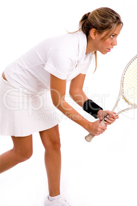 side view of female playing tennis