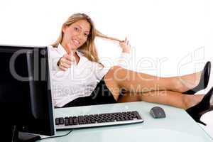 front view of smiling businesswoman showing thumb up in office
