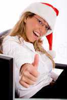 side view of smiling manager with christmas hat showing thumb up