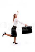 side view of smiling businesswoman running with bag